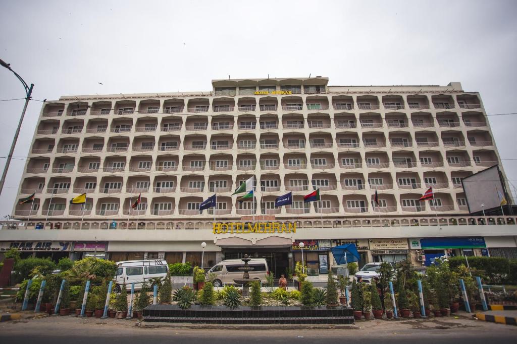 a large building with a large clock on the front of it at Hotel Mehran in Karachi