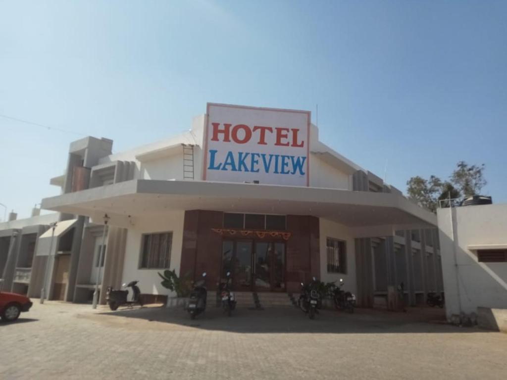 a hotel with motorcycles parked in front of it at Hotel Lakeview in Bhuj