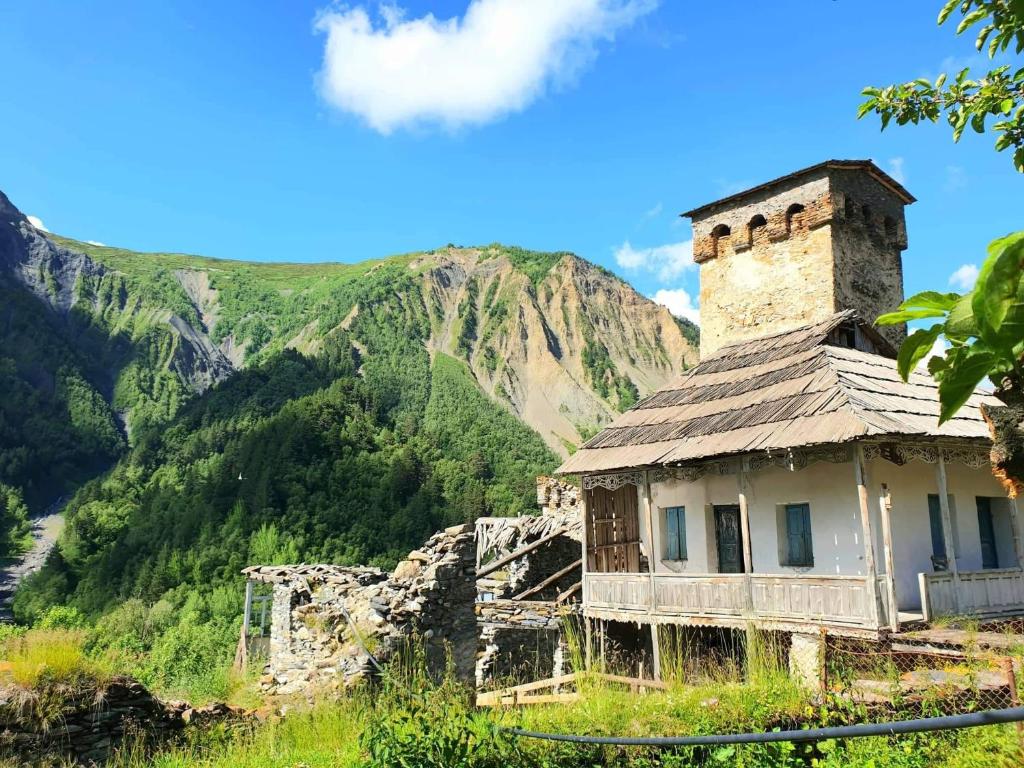 an old building with a mountain in the background at Panorama guesthouse Mata C. in Adishi