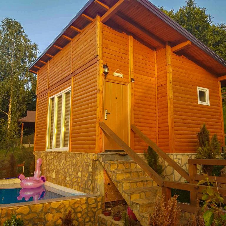 a small wooden house with a pool in front of it at Apartment Little Paradise in Visoko