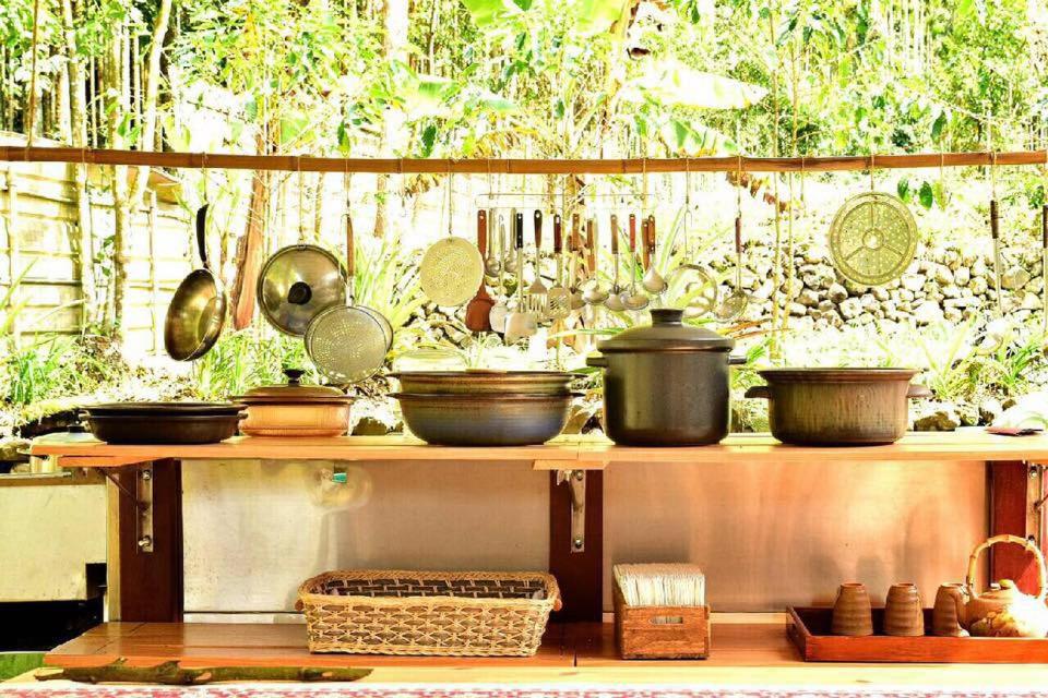 a shelf with many pots and pans on it at Real Food Kitchen Nature Stay B&B in Yuchi
