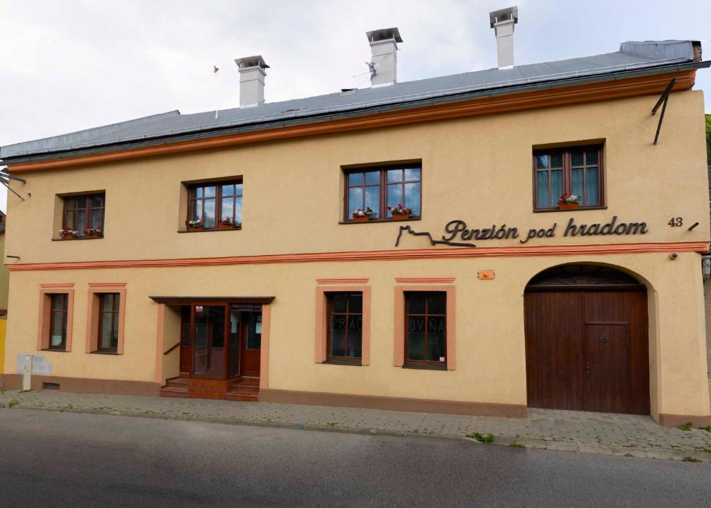 a building with a large door in front of it at Penzión pod hradom Gelnica in Gelnica