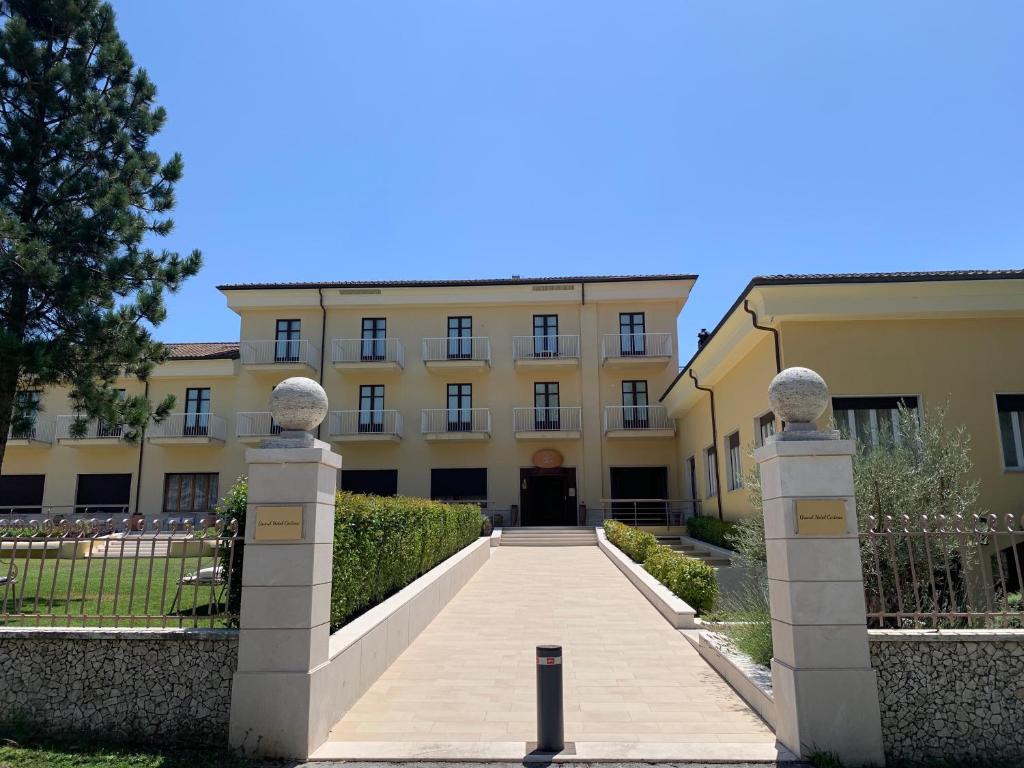 a building with a walkway in front of it at Hotel Certosa in Padula