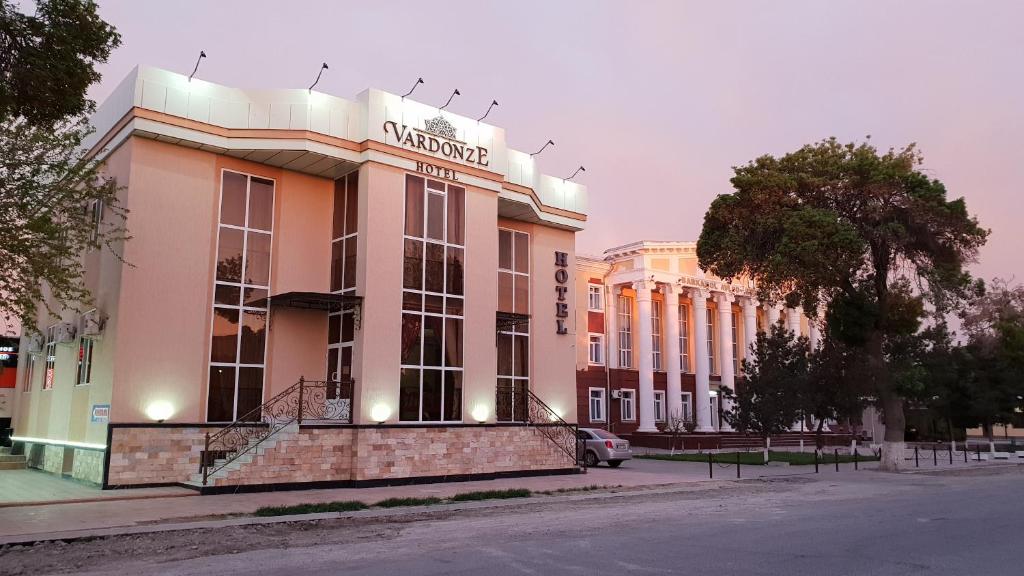 un bâtiment avec un panneau sur son côté dans l'établissement Hotel Vardonze, à Boukhara