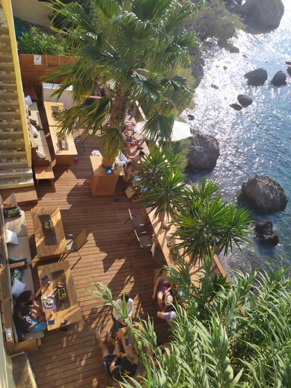 an overhead view of a resort with palm trees and the water at Fatolitis Studios in Masouri