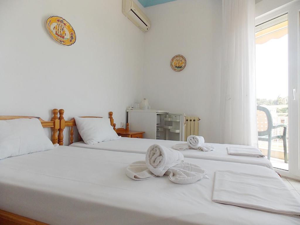 Postel nebo postele na pokoji v ubytování Hotel Sgouridis