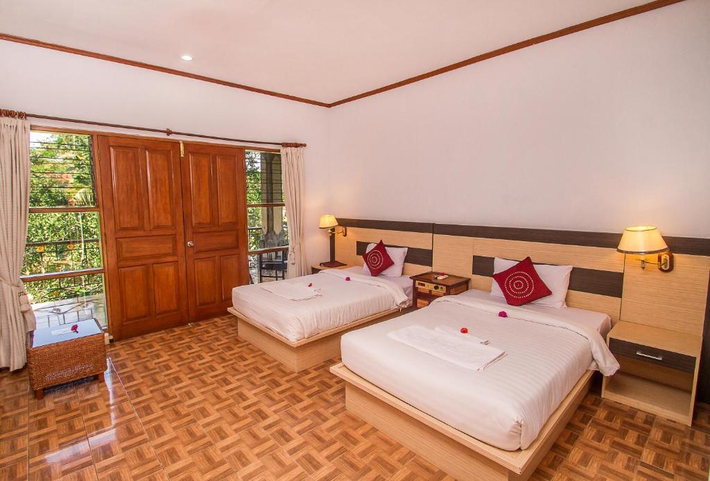 Postel nebo postele na pokoji v ubytování Puri Saron Hotel Madangan - Gianyar