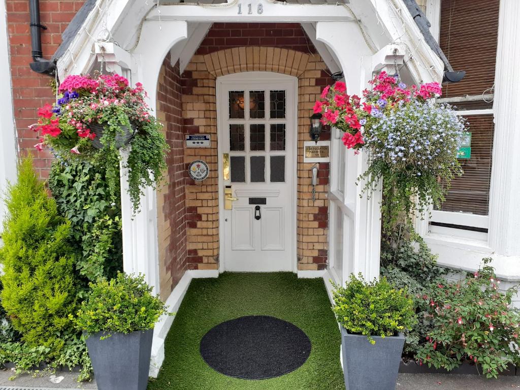 a front door of a house with flowers at The Abbey House Hotel in Reading