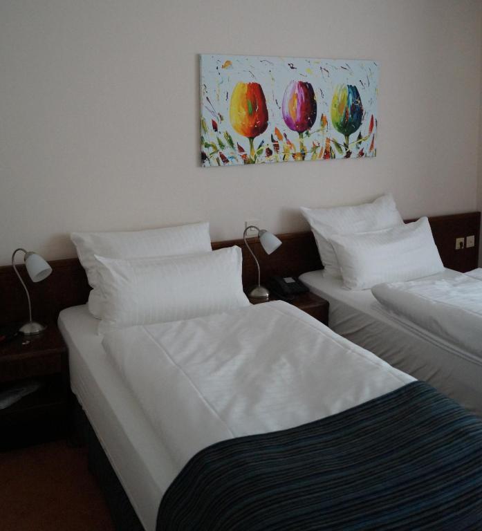 Postel nebo postele na pokoji v ubytování Hotel Forsthaus St. Hubertus