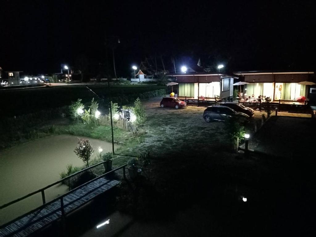 a view of a parking lot at night at บวกบัววิวรีสอทร์ in Nan