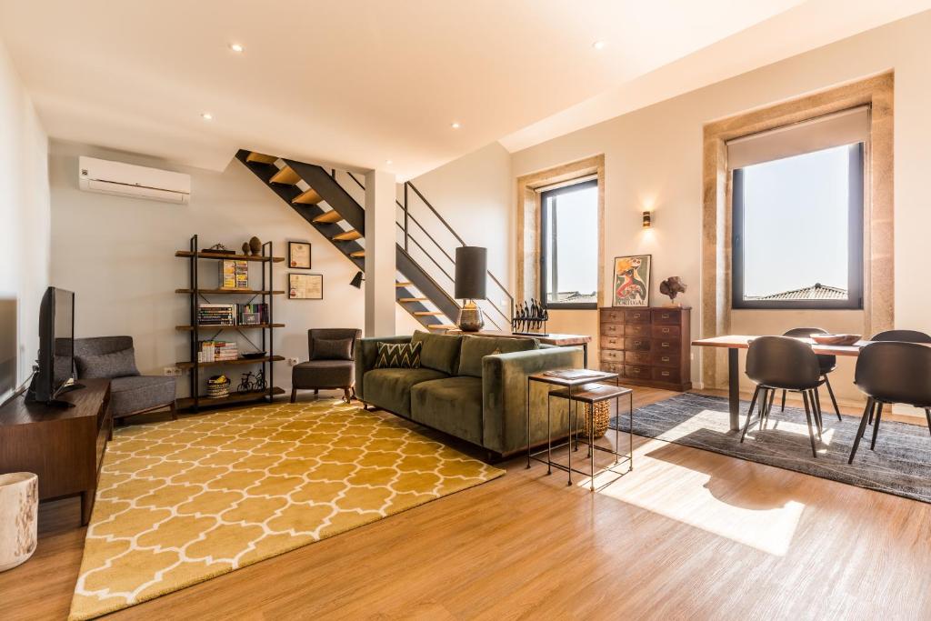 a living room with a couch and a table at Lofts - Casa do Metro in Póvoa de Varzim