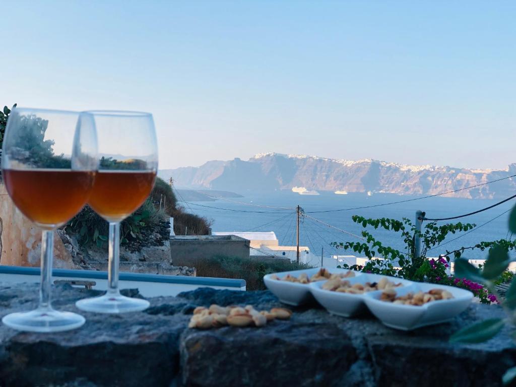 two glasses of wine and a bowl of food at Marann Cave in Akrotiri