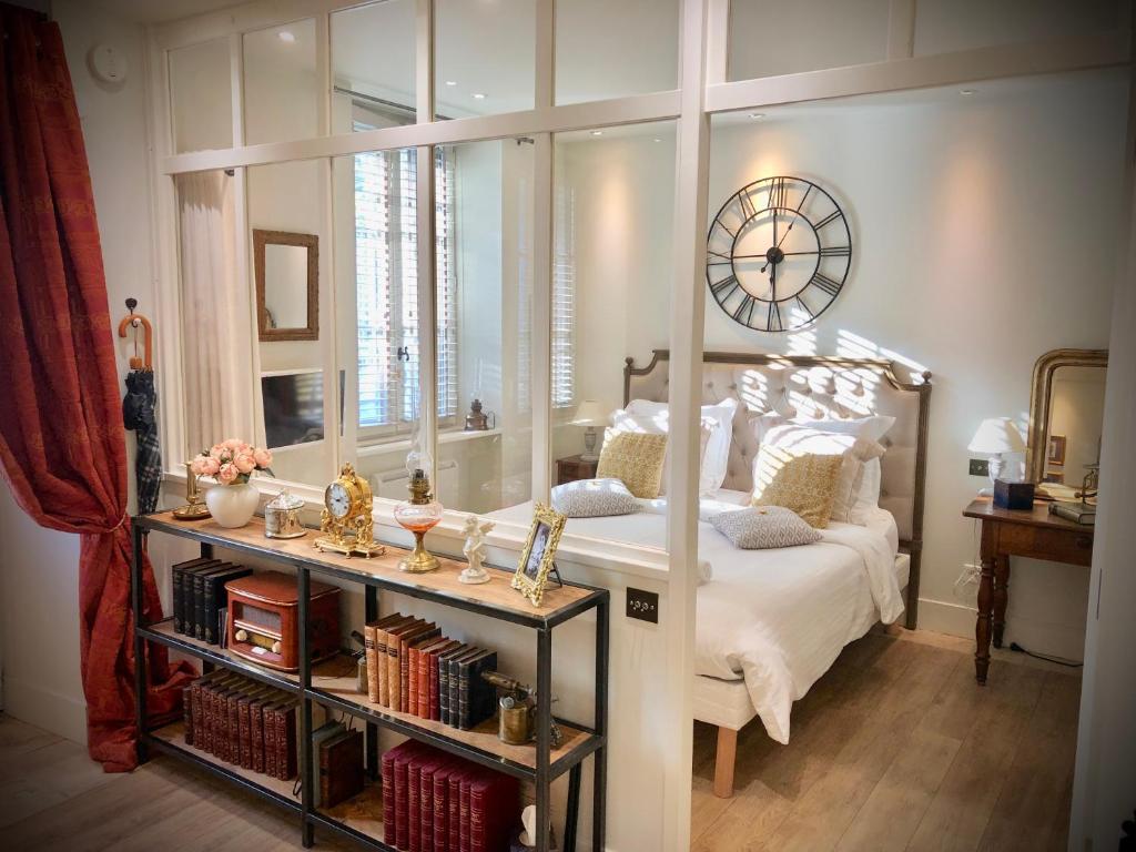 een slaapkamer met een bed en een grote spiegel bij Le Secret - Avignon in Avignon