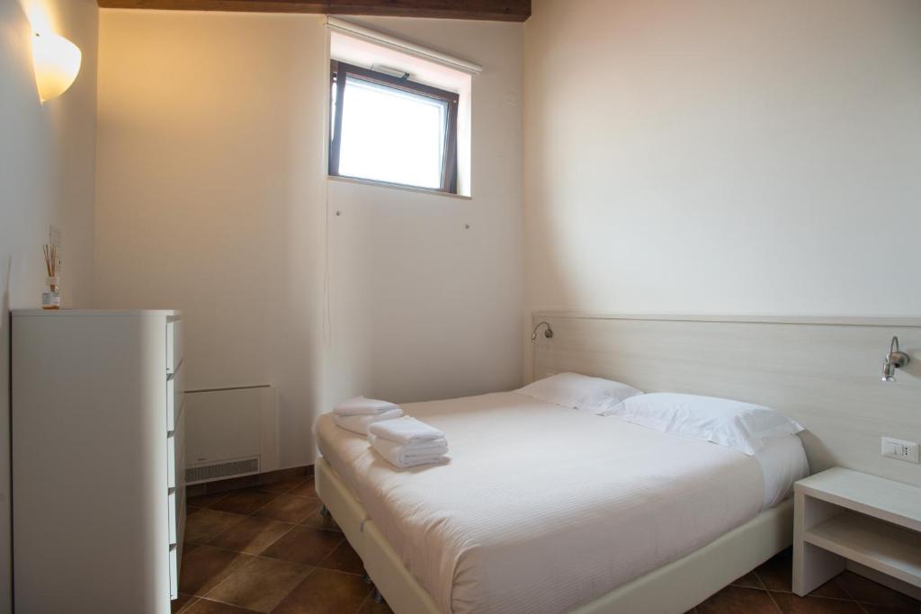 Postel nebo postele na pokoji v ubytování Tenute D'Onghia