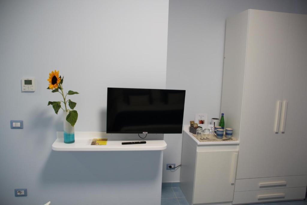 a tv sitting on top of a white wall at BLU SEA SORRENTO in Sorrento