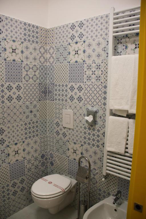 a bathroom with a toilet and a sink at BLU SEA SORRENTO in Sorrento
