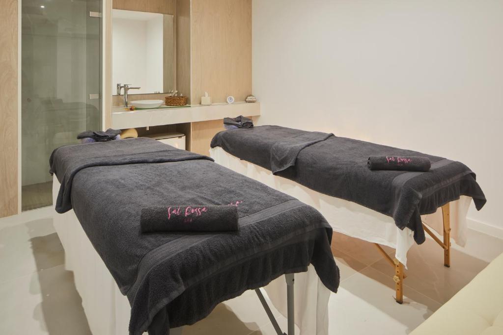 a group of blue towels sitting in a room at Hotel Torre del Mar - Ibiza in Playa d'en Bossa