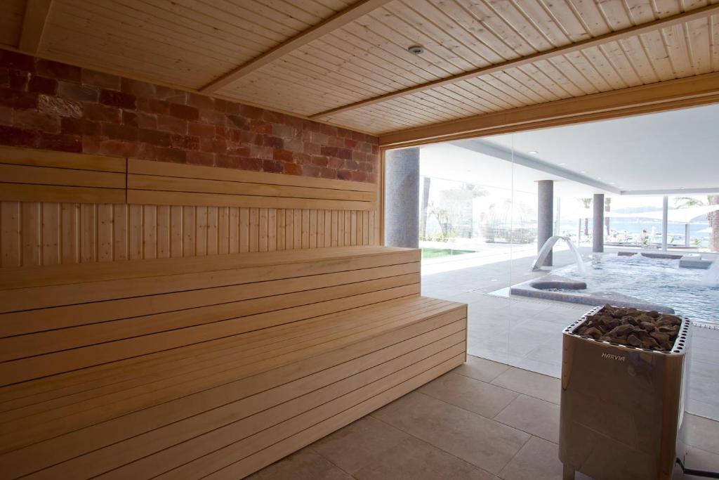 a sauna with a large window and a tub at Hotel Torre del Mar - Ibiza in Playa d'en Bossa