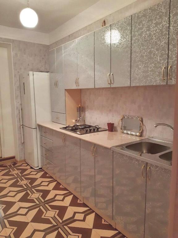 a kitchen with a sink and a refrigerator at SPARTA Apartment Complex in Sevan