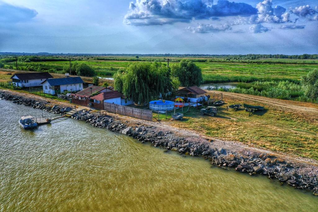 an aerial view of a village next to a river at La Nea Paul in Maliuc