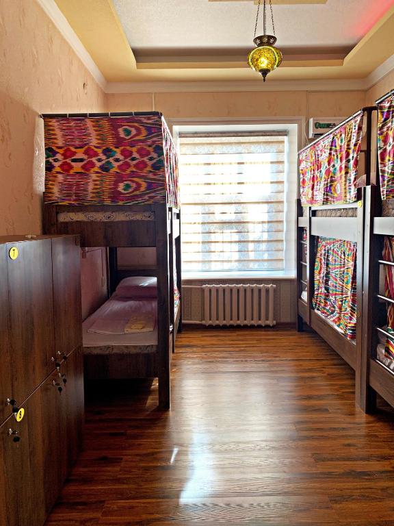 a room with two bunk beds and a window at Hostel Imona in Samarkand