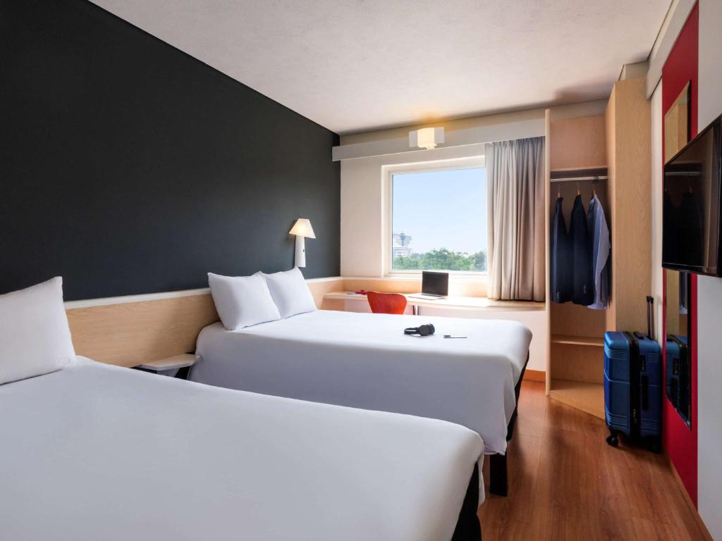 Postel nebo postele na pokoji v ubytování Ibis Guadalajara Expo