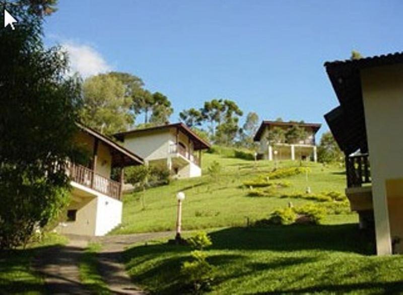 a green field with houses on top of it at Pousada Lua e Sol in Santo Antônio do Pinhal