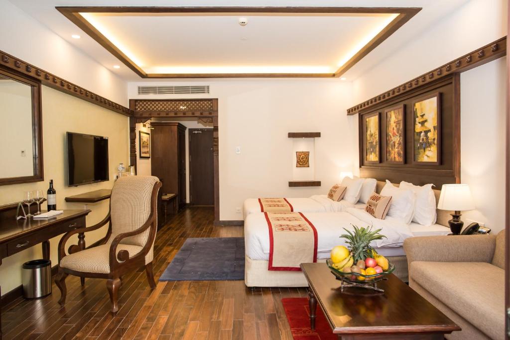 a hotel room with a bed and a living room at Chandragiri Hills Resort in Thānkot