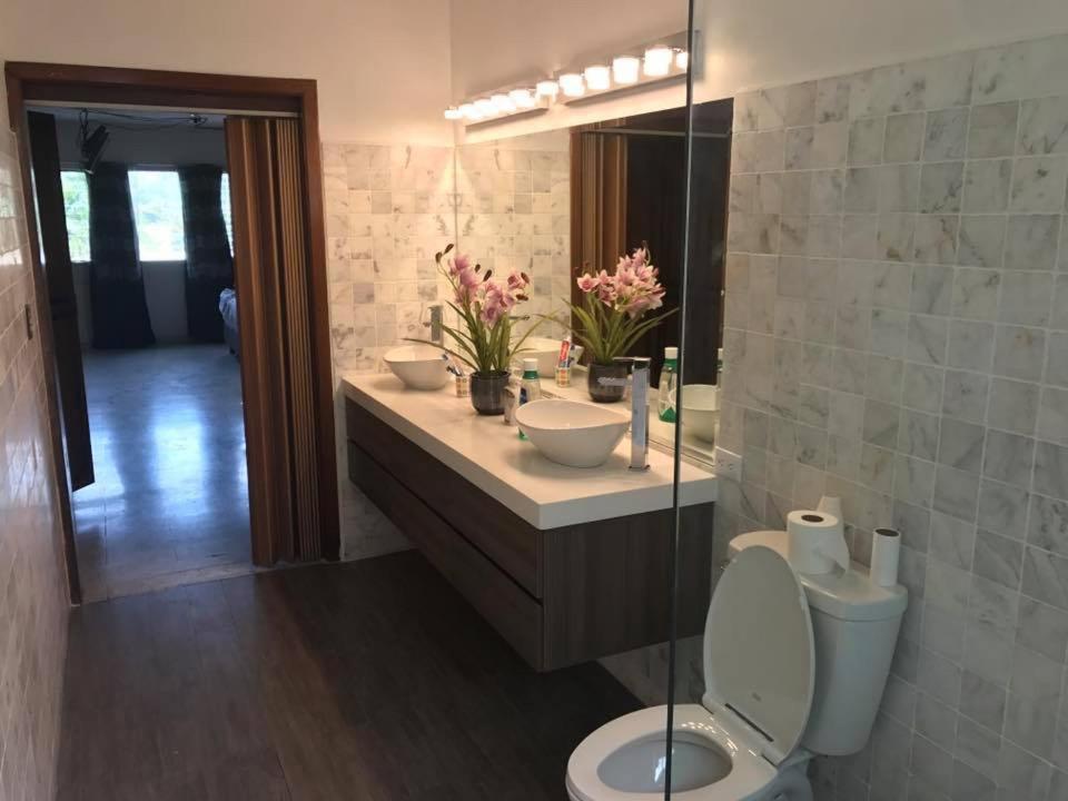 a bathroom with a toilet and a sink and a mirror at Palmira Hostel in Tegucigalpa