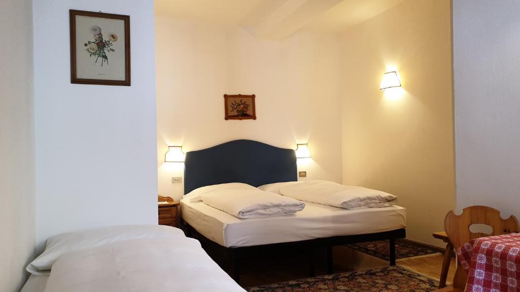 Posteľ alebo postele v izbe v ubytovaní Hotel Bellaria - Cortina d'Ampezzo
