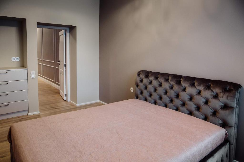 um quarto com uma cama e uma cómoda em Kranto apartamentai em Panevėžys