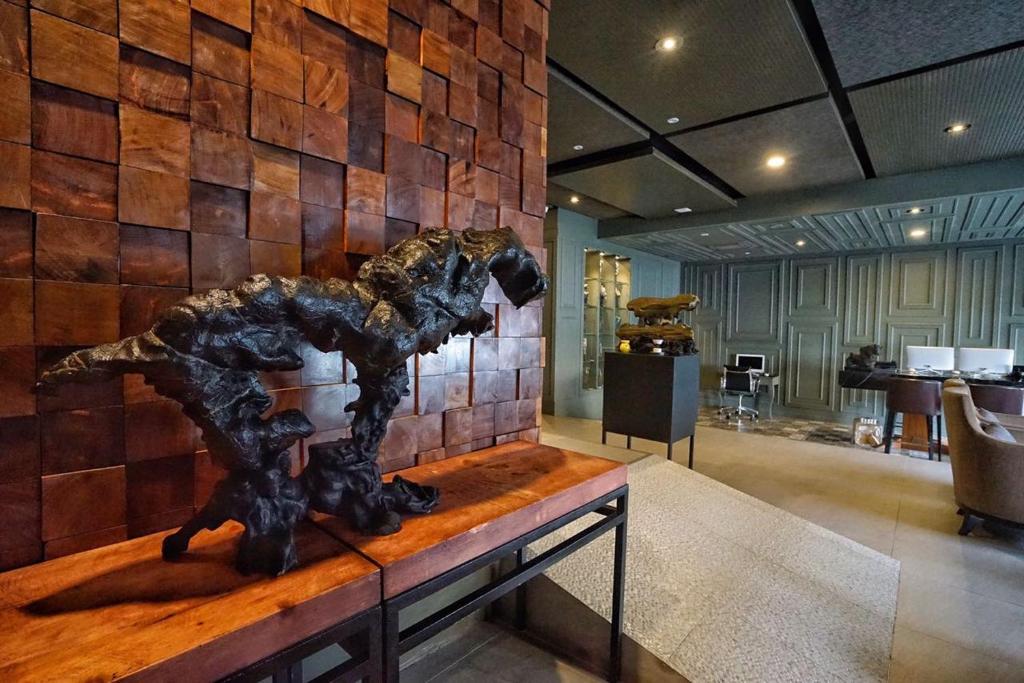 a statue of a horse on a table in a room at Bedrock Hotel Ipoh in Ipoh