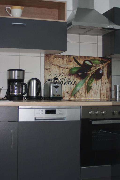 a kitchen with a stove and a counter top at Ferienzimmer Tielesch in Gadsdorf