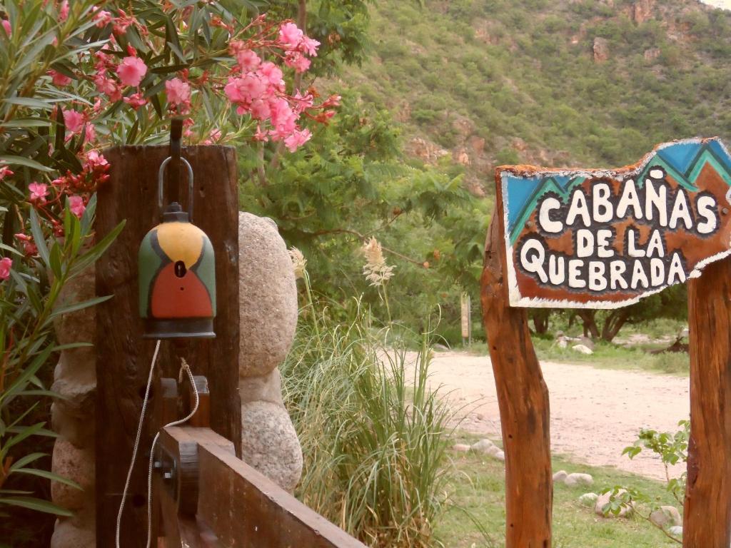 a teddy bear is standing next to a sign at CABAÑAS DE LA QUEBRADA in San Marcos Sierras