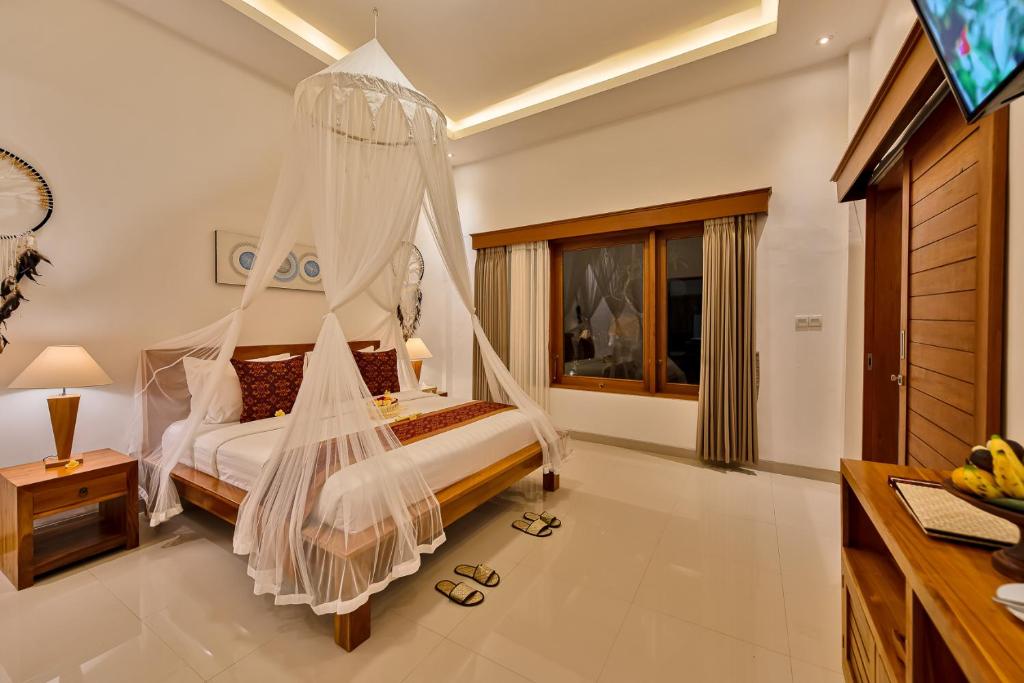 Postel nebo postele na pokoji v ubytování Cenik Villa Ubud