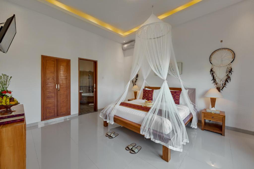 Postel nebo postele na pokoji v ubytování Cenik Villa Ubud