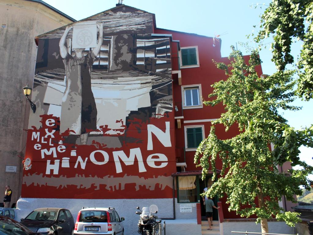 een muurschildering aan de zijkant van een gebouw bij Appartamenti La Quiete in Mele