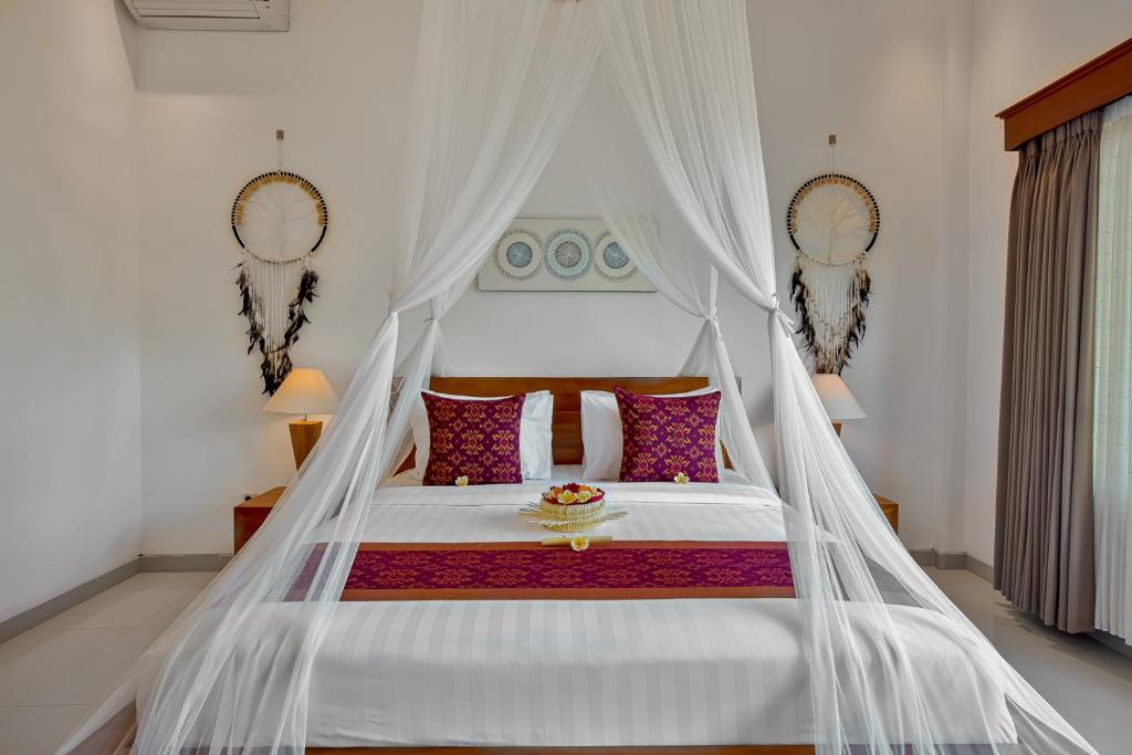Postel nebo postele na pokoji v ubytování Cenik Villa Ubud