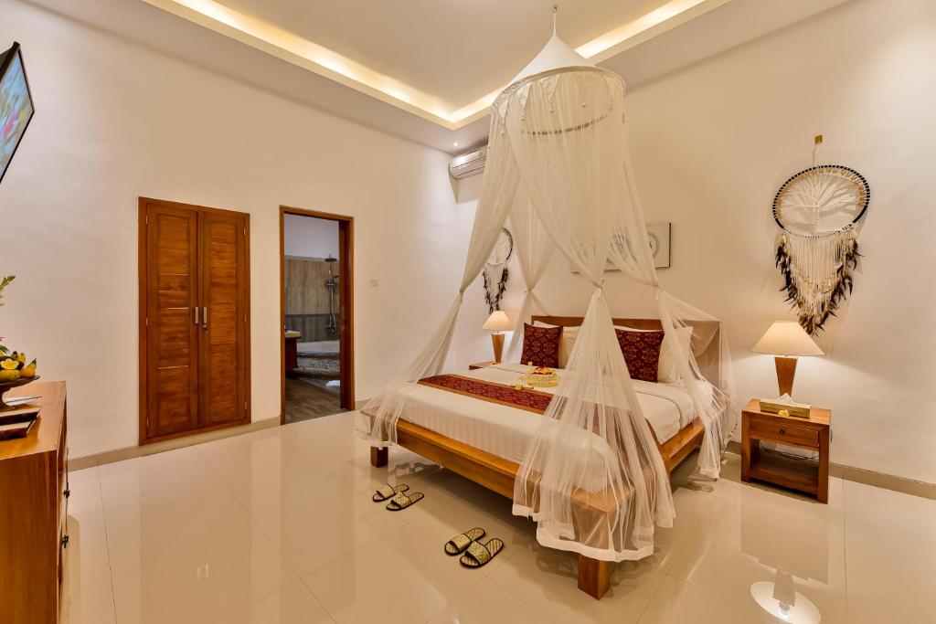 Postel nebo postele na pokoji v ubytování Cenik Villa Ubud