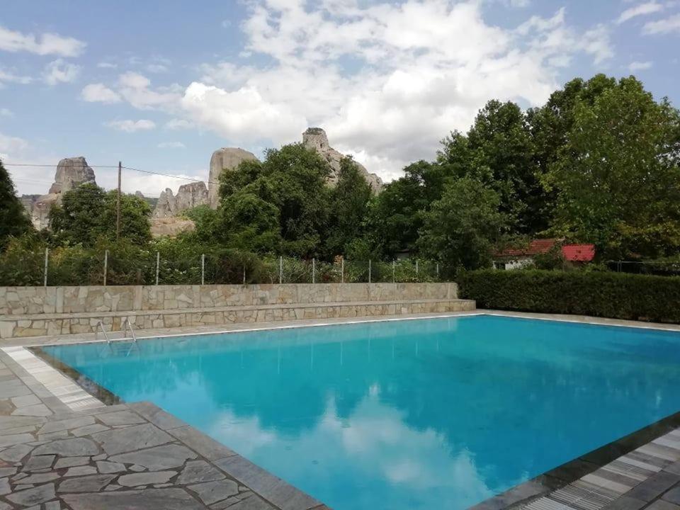 a swimming pool with a mountain in the background at Meteora Garden in Kalabaka