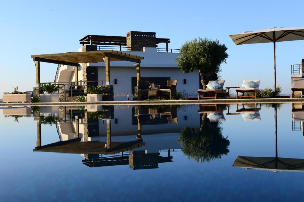 a house with its reflection in the water at Vistas - Herdade do Zambujal in Castro Verde