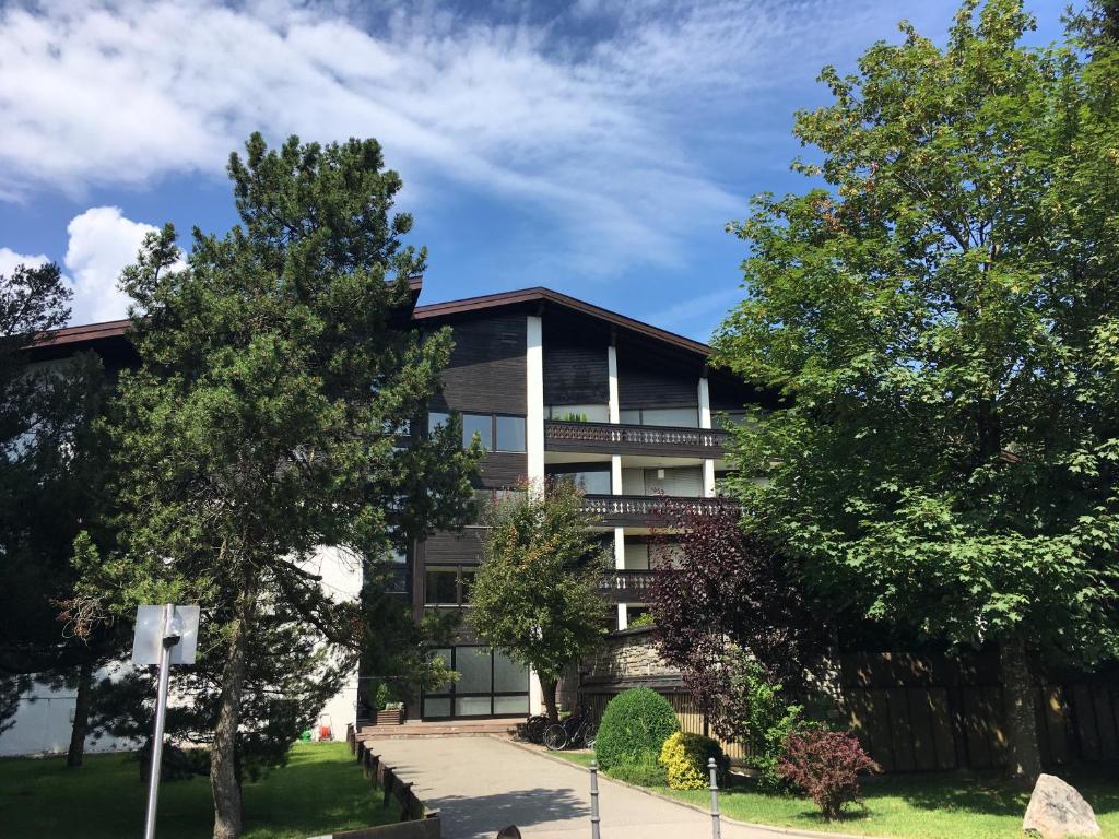 an apartment building with trees in front of it at Ferienwohnung Ewa in Grassau