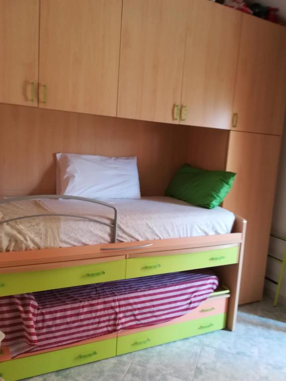 a bedroom with a bed with a wooden cabinet at B&B Is Pranus a Mari Casa Privata in Solanas