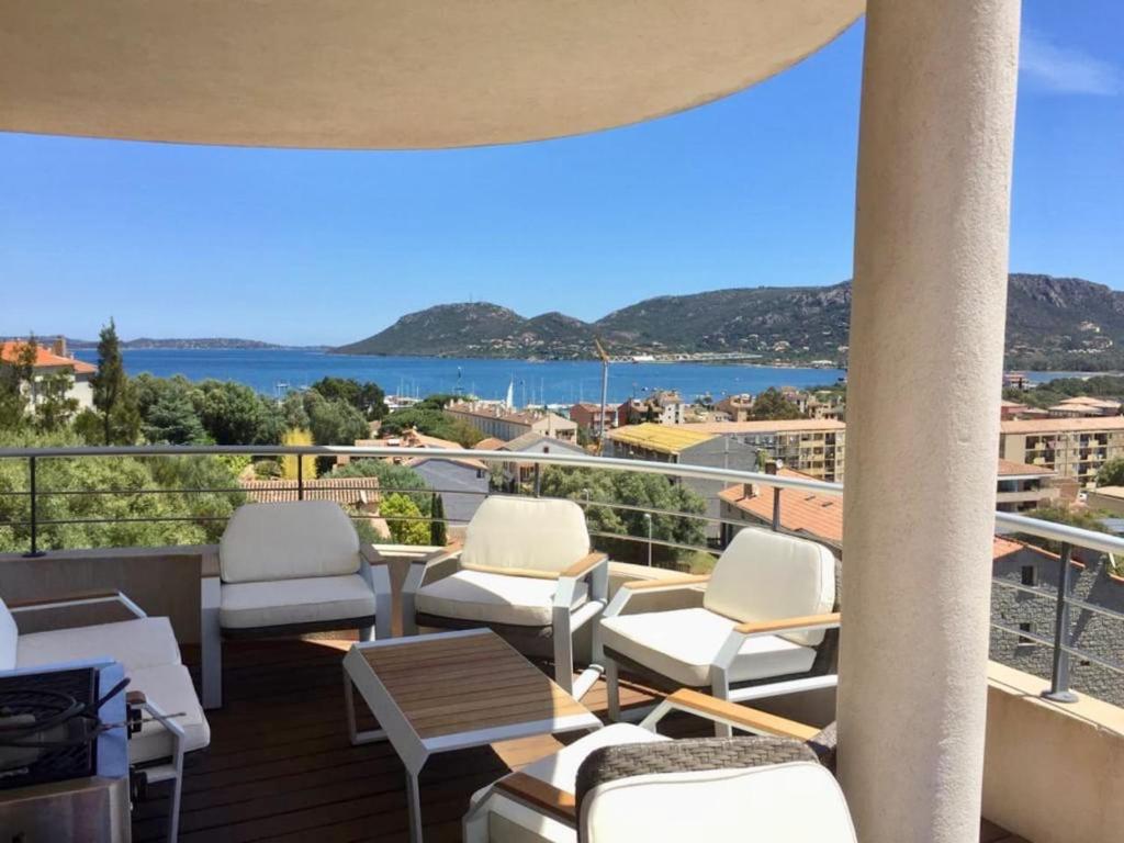 a balcony with chairs and a view of the water at Le Haut de la Vague in Porto-Vecchio