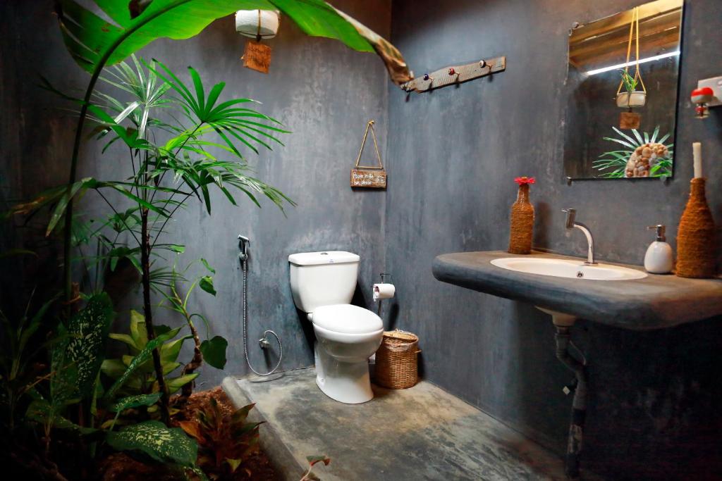 a bathroom with a toilet and a sink at Chez Podi Surf Stay in Mirissa