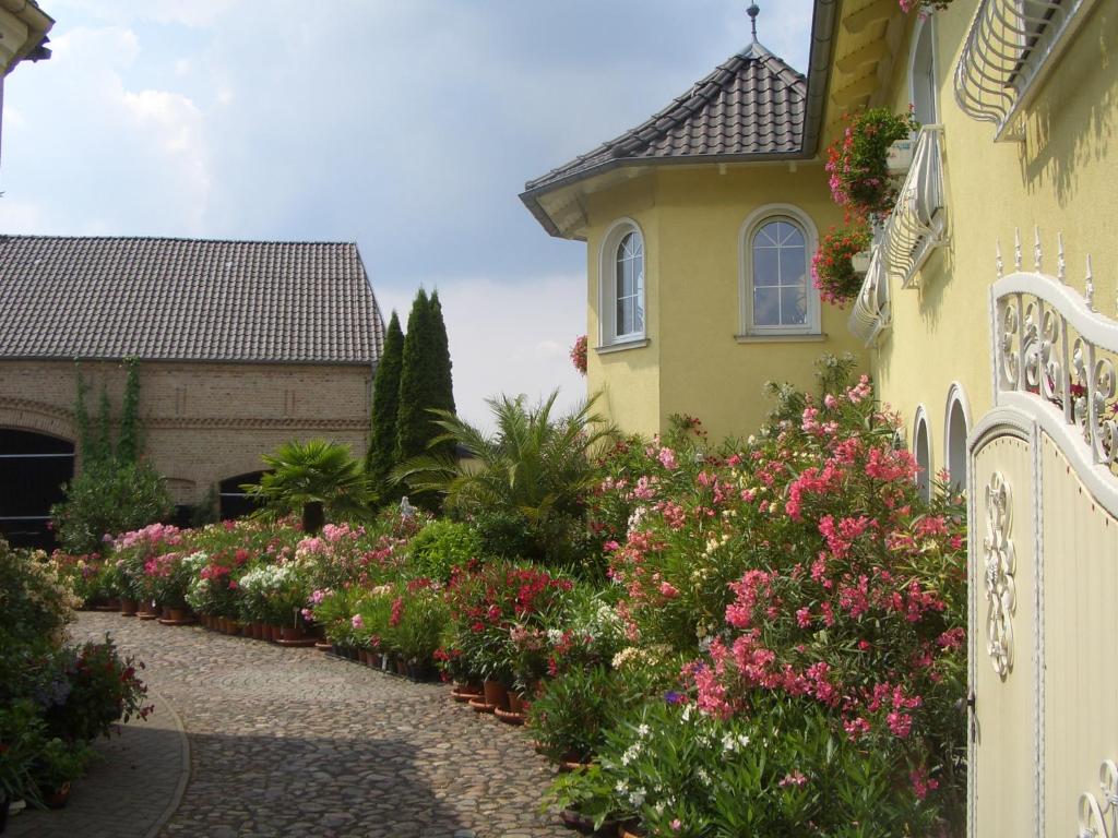 a garden of flowers in front of a house at Ferienwohnung Oleanderhof in Zossen