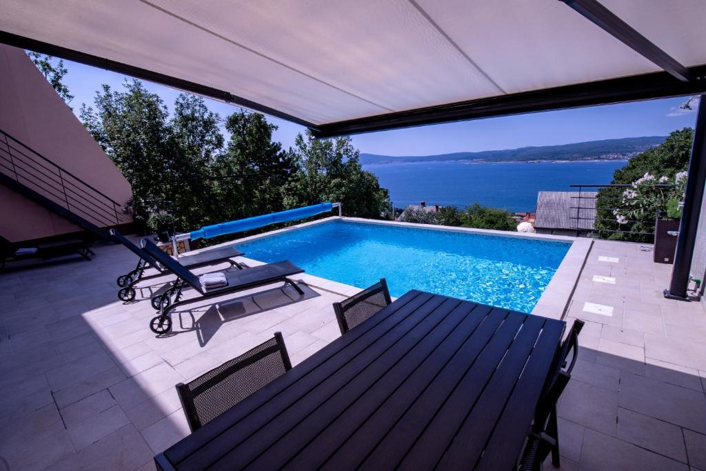 a swimming pool with a view of the water at The View Residence in Crikvenica
