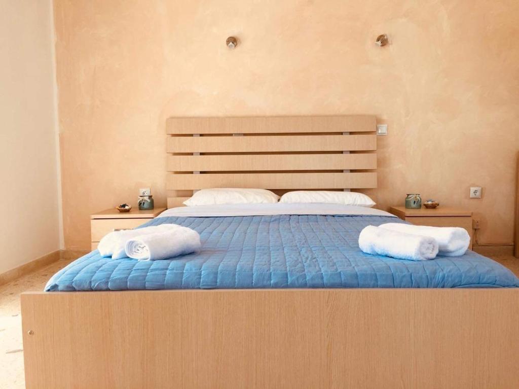 a bedroom with a bed with two towels on it at Santa Marina Rooms in Agia Marina Aegina