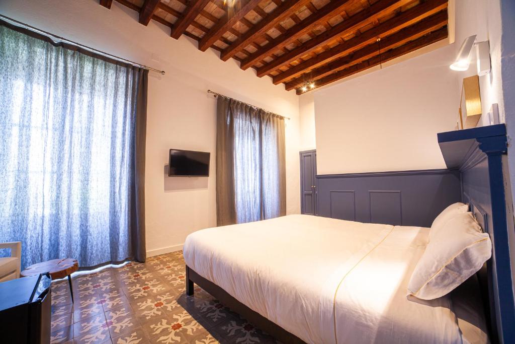 Postel nebo postele na pokoji v ubytování Apartahotel Siglo XIX