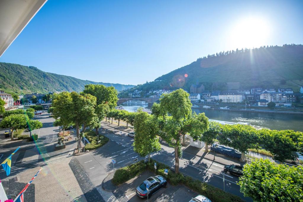 a view of a city with a river and trees at Hotel Karl Müller in Cochem